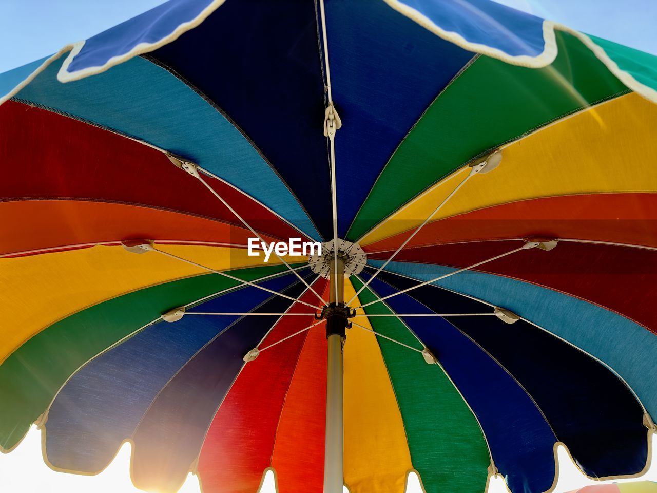 Low angle view of multi colored beach umbrella