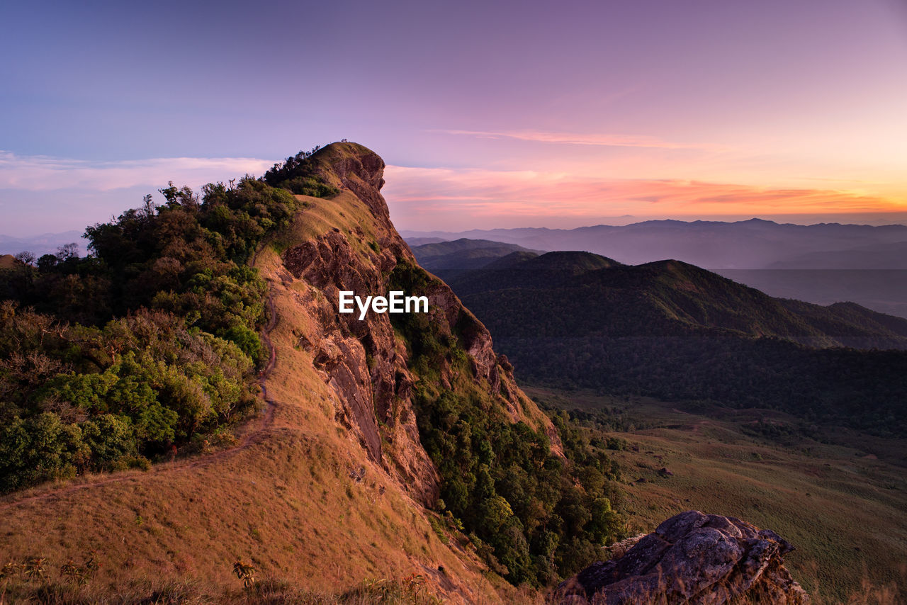 Scenic view of rocky mountains against sky during sunset