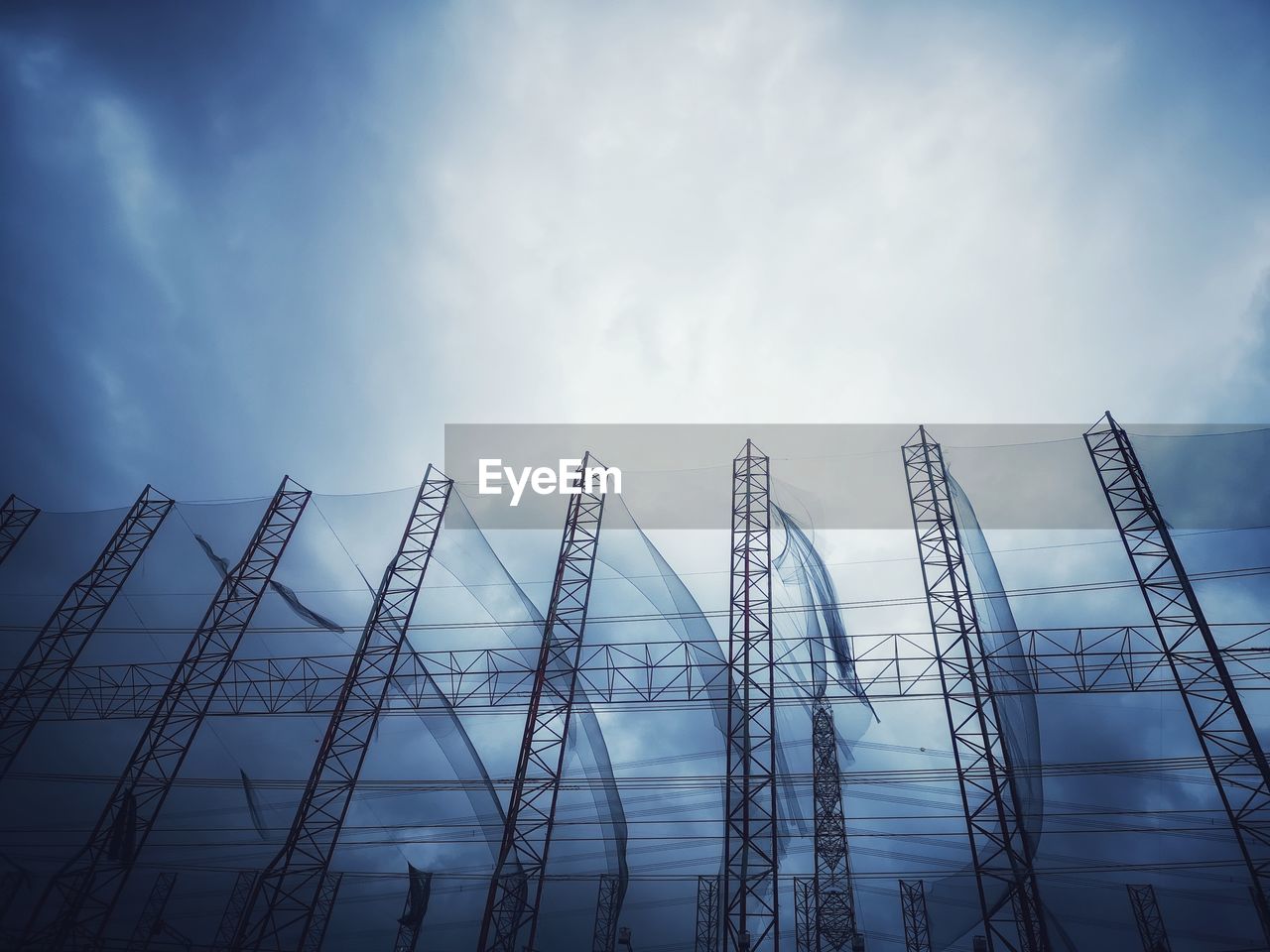 Low angle view of metal structure against sky at construction site