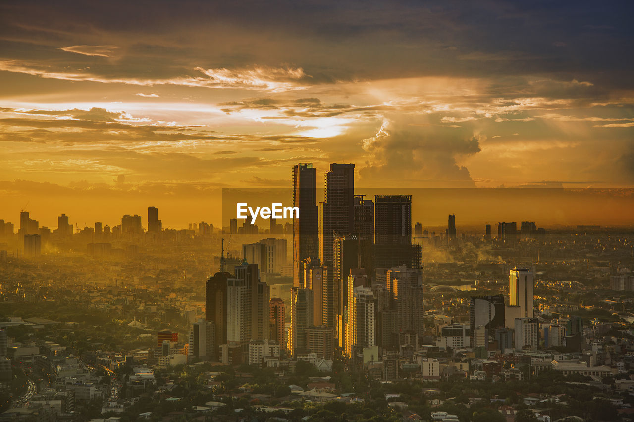 Panoramic view of modern buildings against sky during sunset