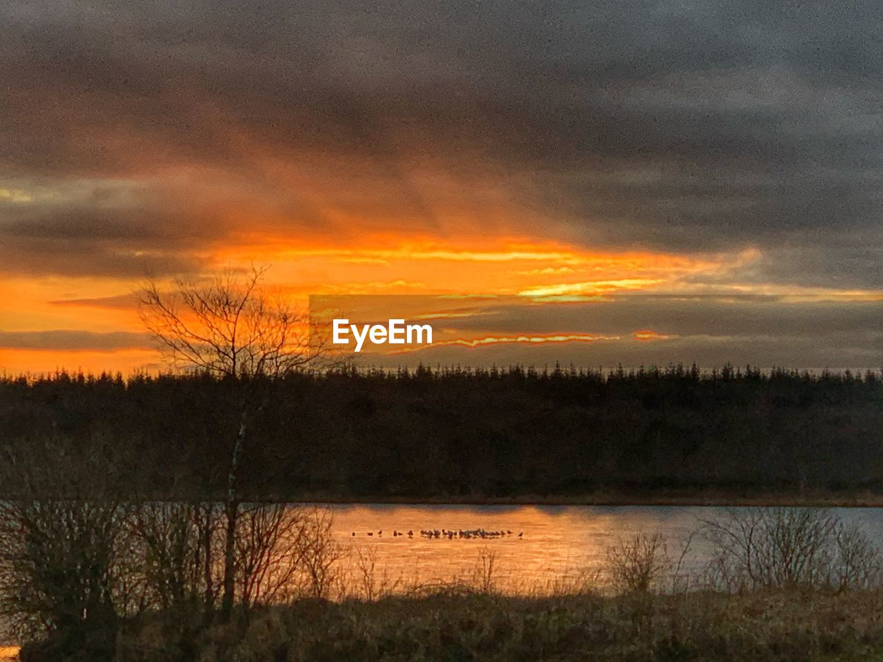 SCENIC VIEW OF SUNSET OVER LAKE