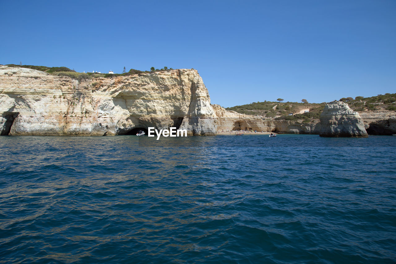 Scenic view of sea against clear blue sky