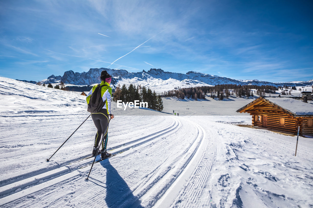 PERSON ON SNOWCAPPED MOUNTAIN AGAINST SKY