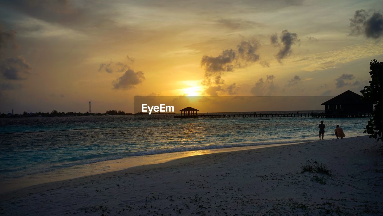 Scenic view of beach against sky during sunset