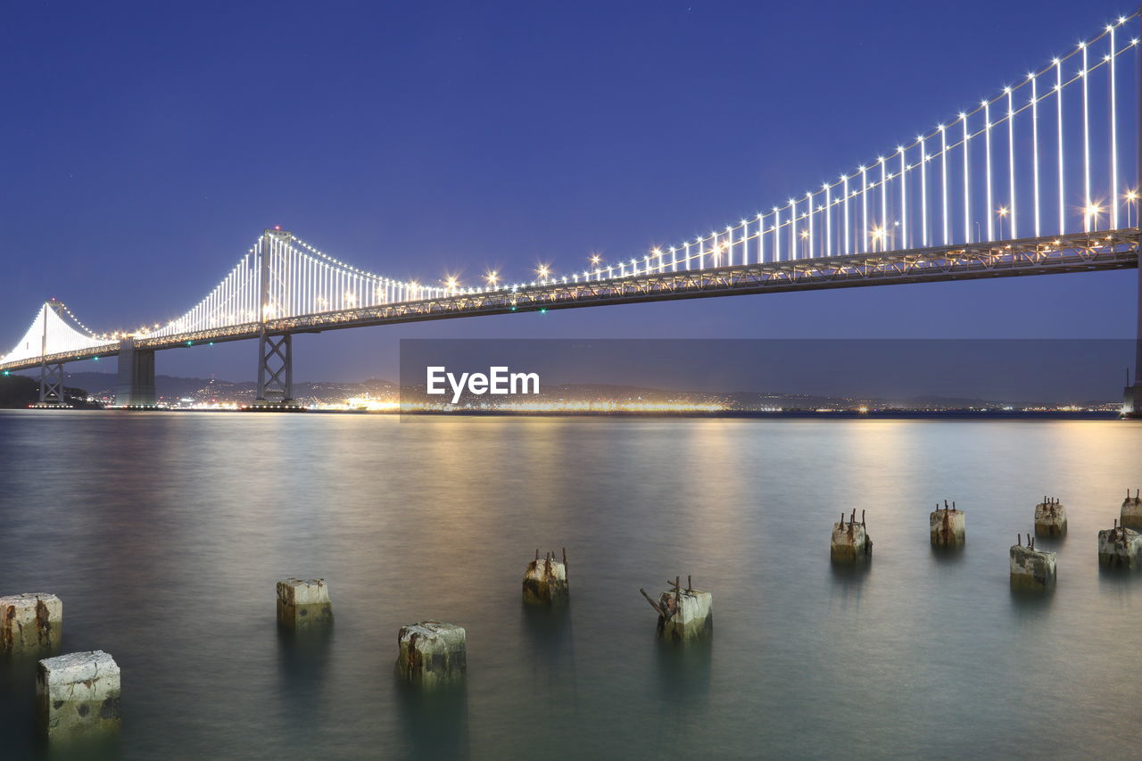 Illuminated bridge over bay at night