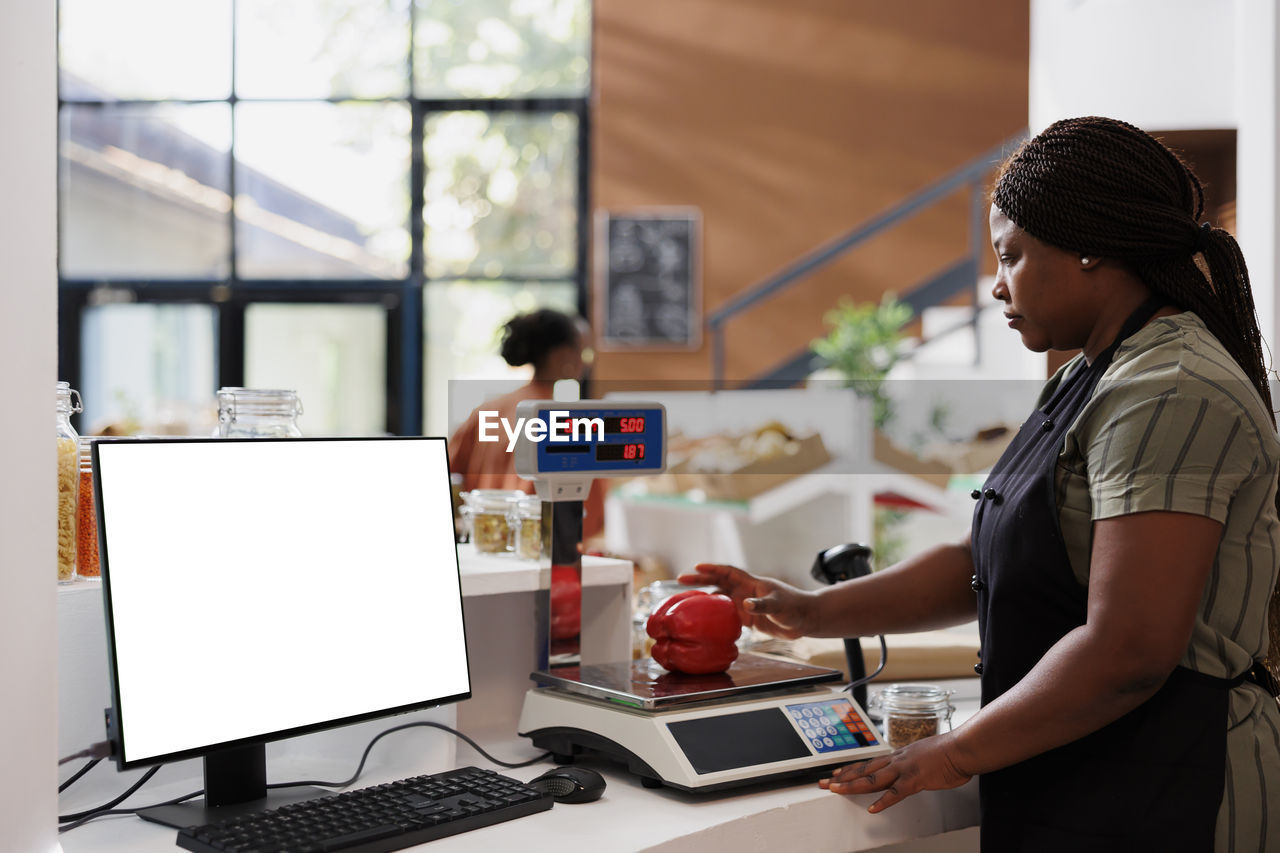 side view of man using laptop at table