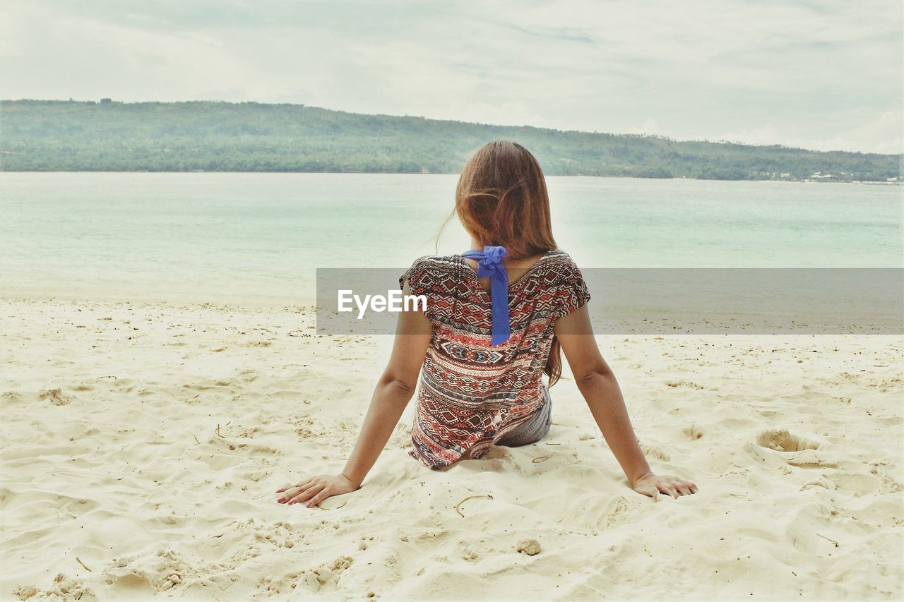 Rear view of girl on beach