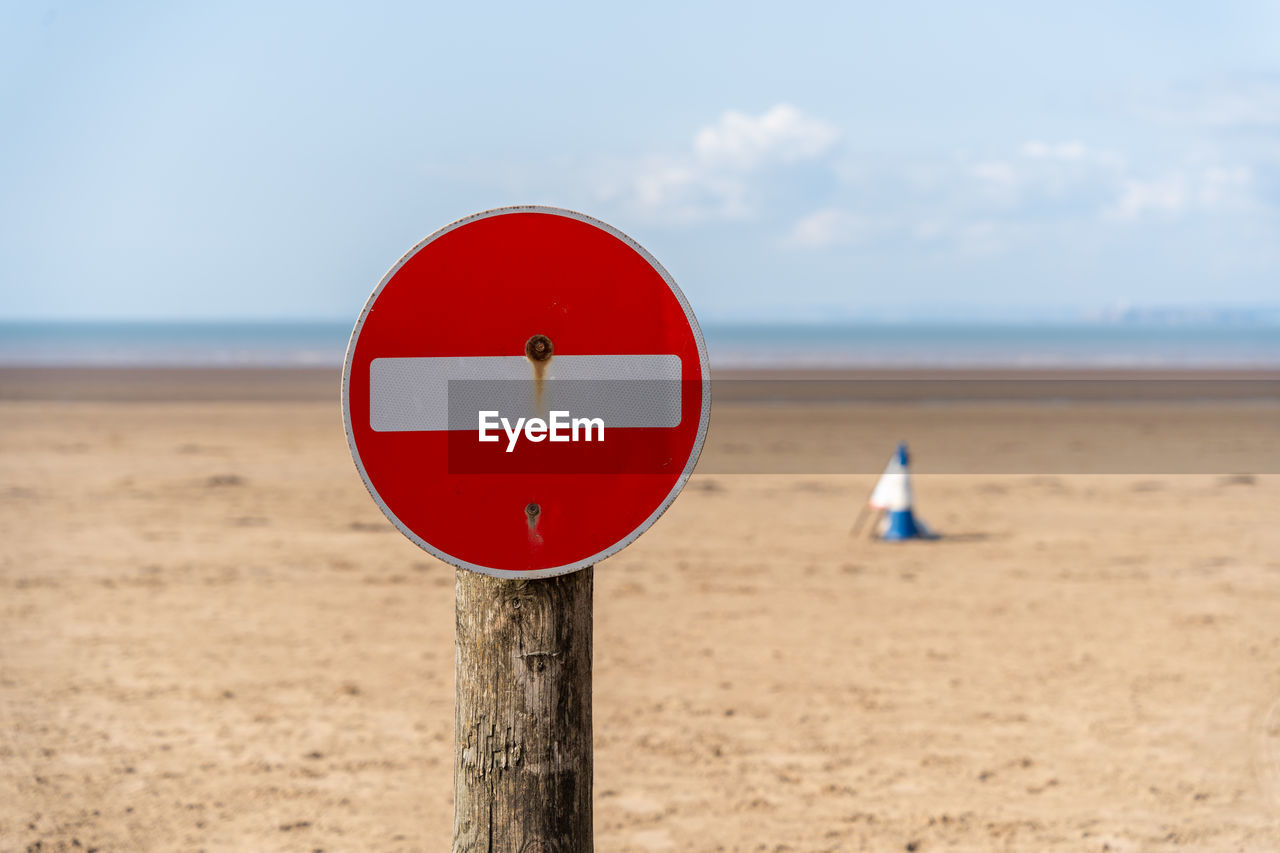 A no parking sign on the beach