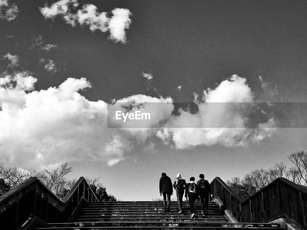 People on staircase against sky