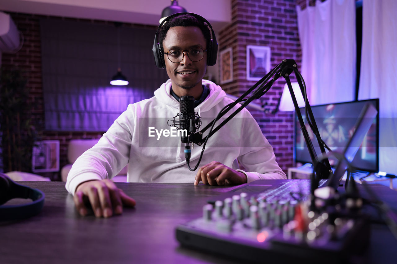 Portrait of male blogger at studio