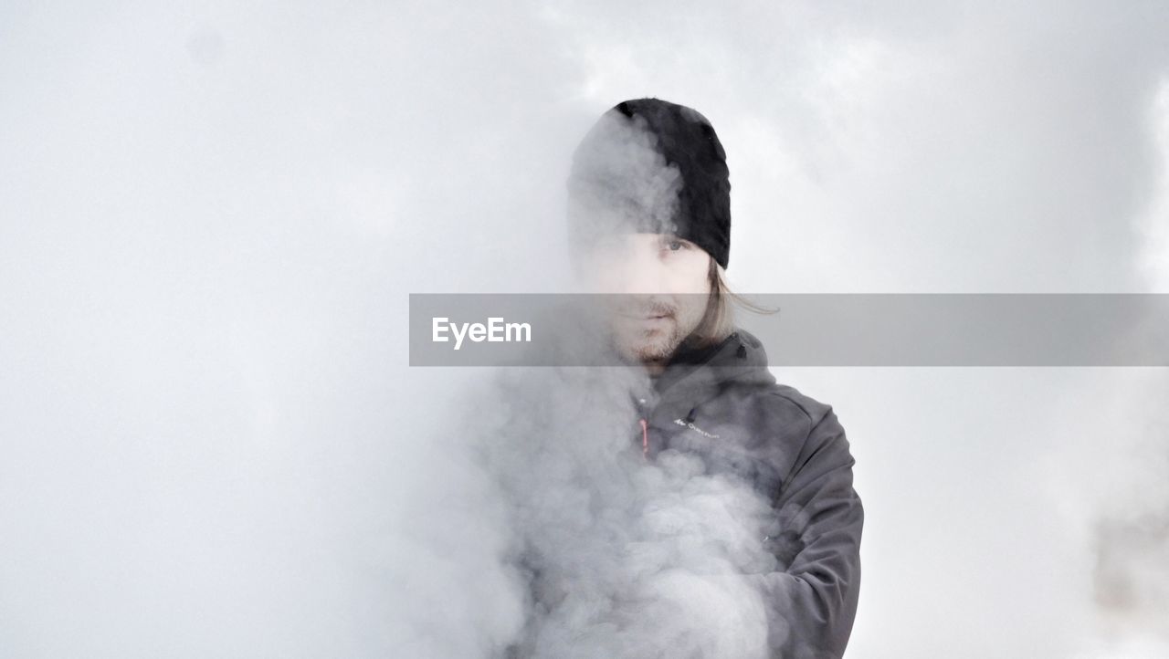 Portrait of man amidst smoke during winter