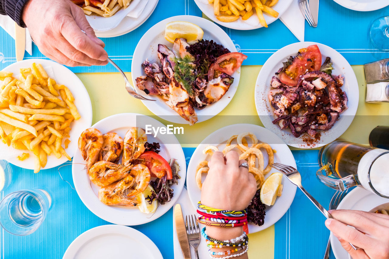 Directly above shot of people eating food at table