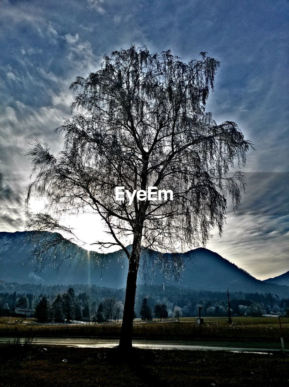 SCENIC VIEW OF MOUNTAINS AGAINST CLOUDY SKY