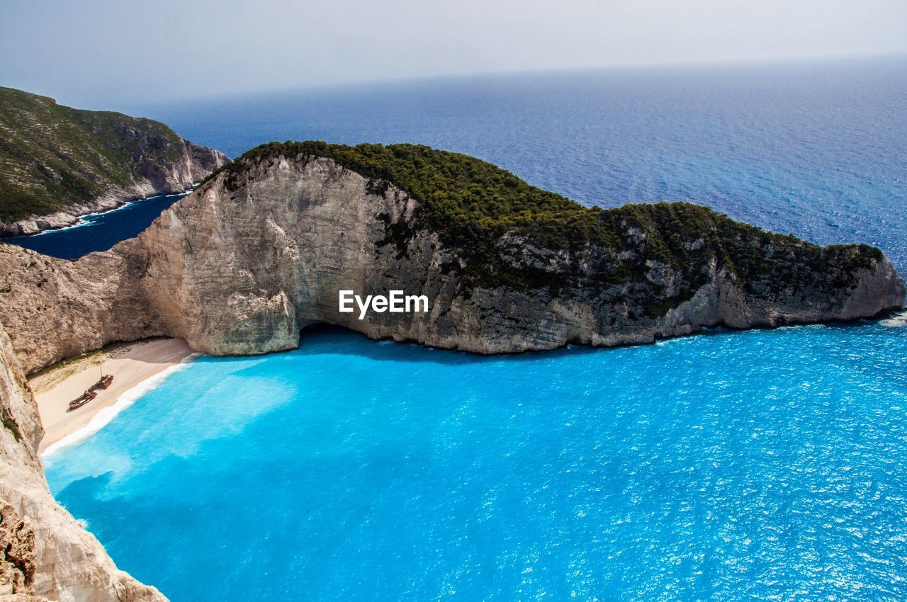 SCENIC VIEW OF SEA WITH ROCKS IN BACKGROUND