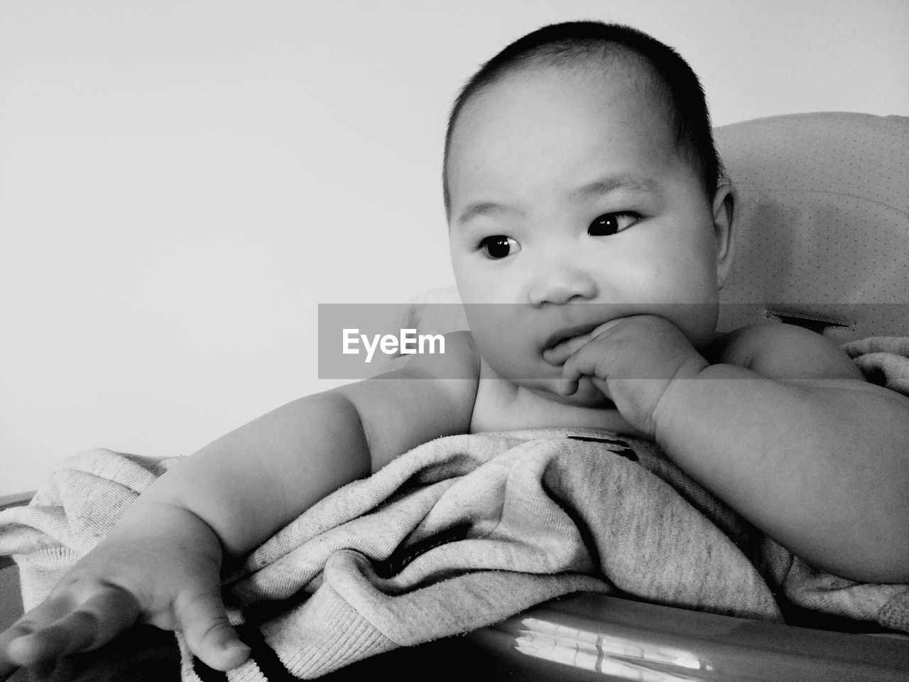 Cute baby sitting in carriage at home