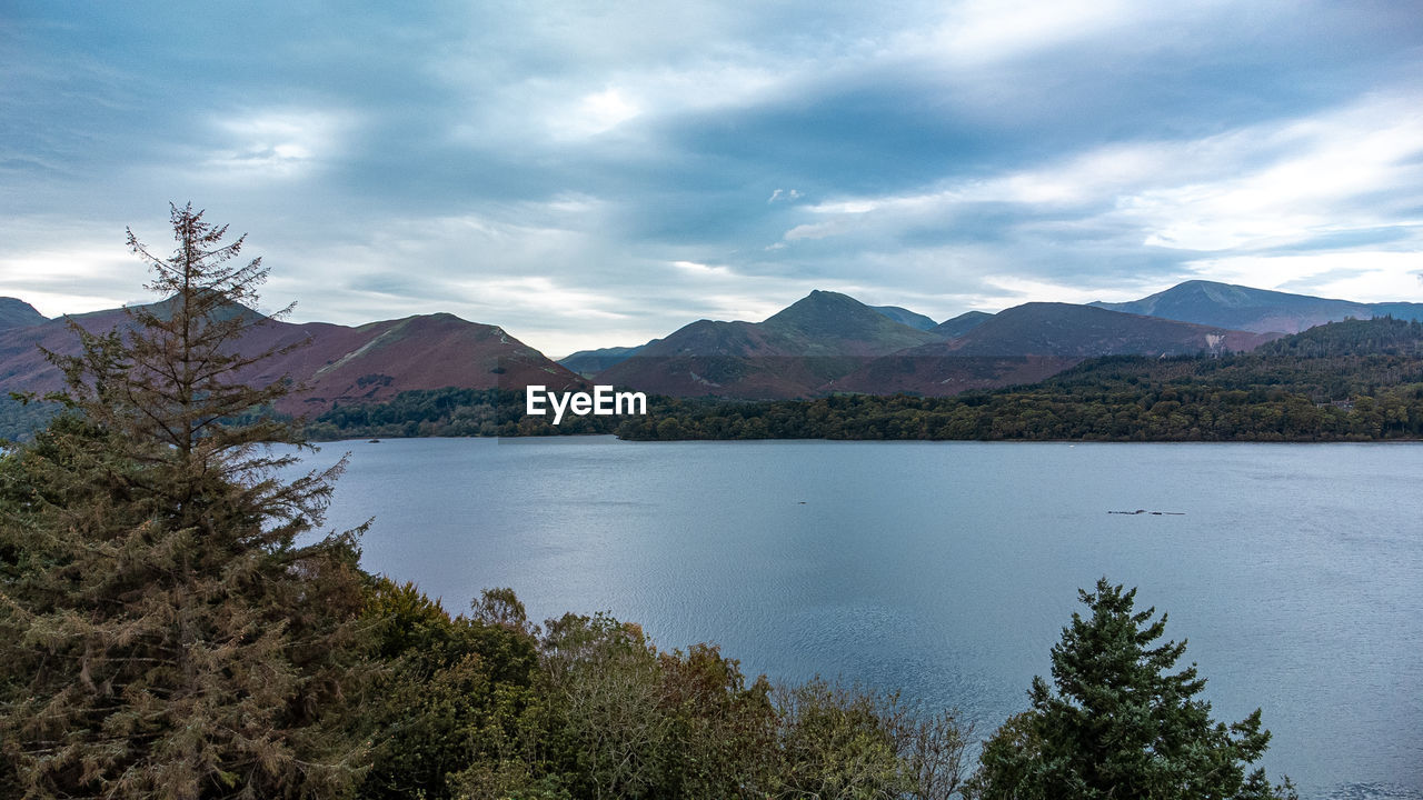 mountain, water, scenics - nature, sky, environment, beauty in nature, lake, landscape, tree, cloud, nature, mountain range, plant, highland, land, wilderness, no people, travel destinations, tranquility, reservoir, tranquil scene, reflection, travel, forest, body of water, tourism, outdoors, coniferous tree, non-urban scene, pinaceae, pine tree, day, idyllic, trip, vacation