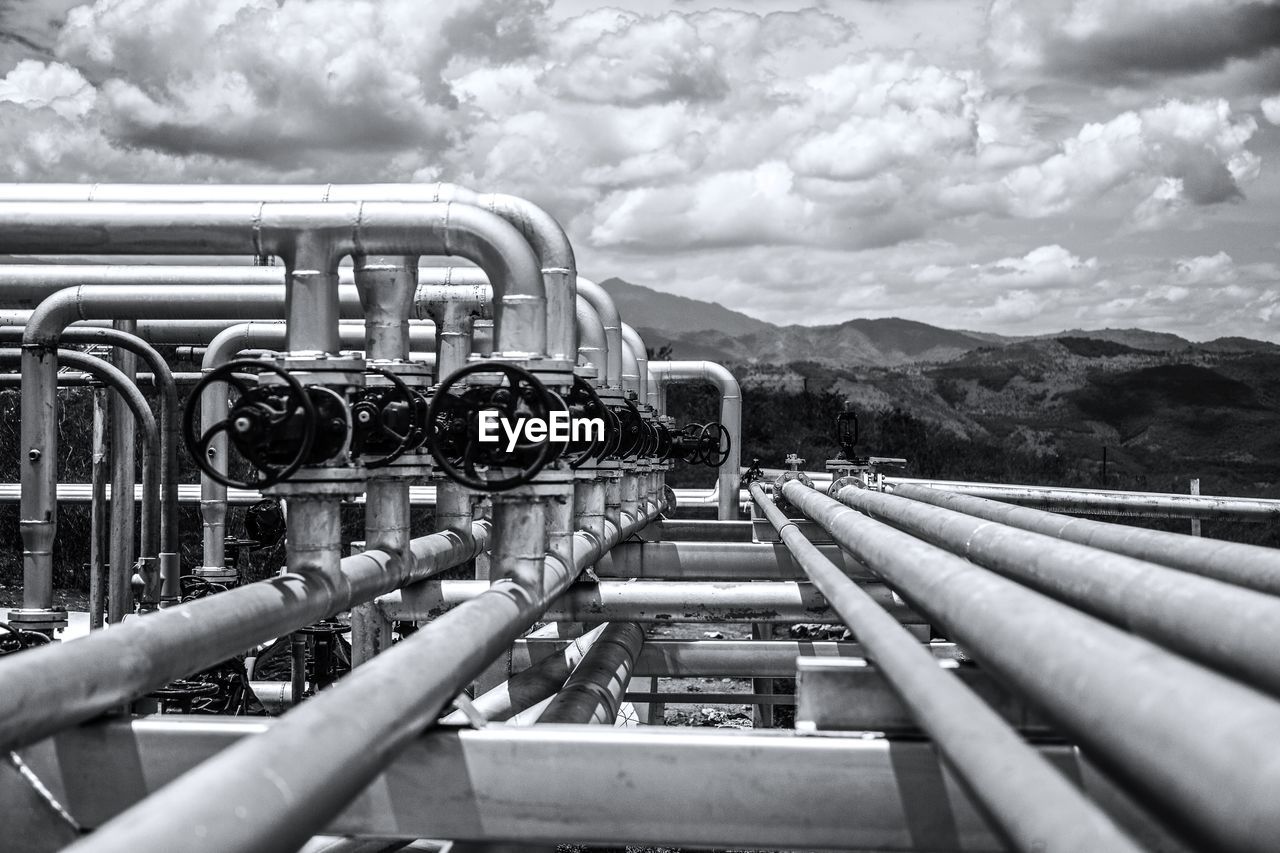 CLOSE-UP OF PIPES AGAINST SKY ON MOUNTAIN