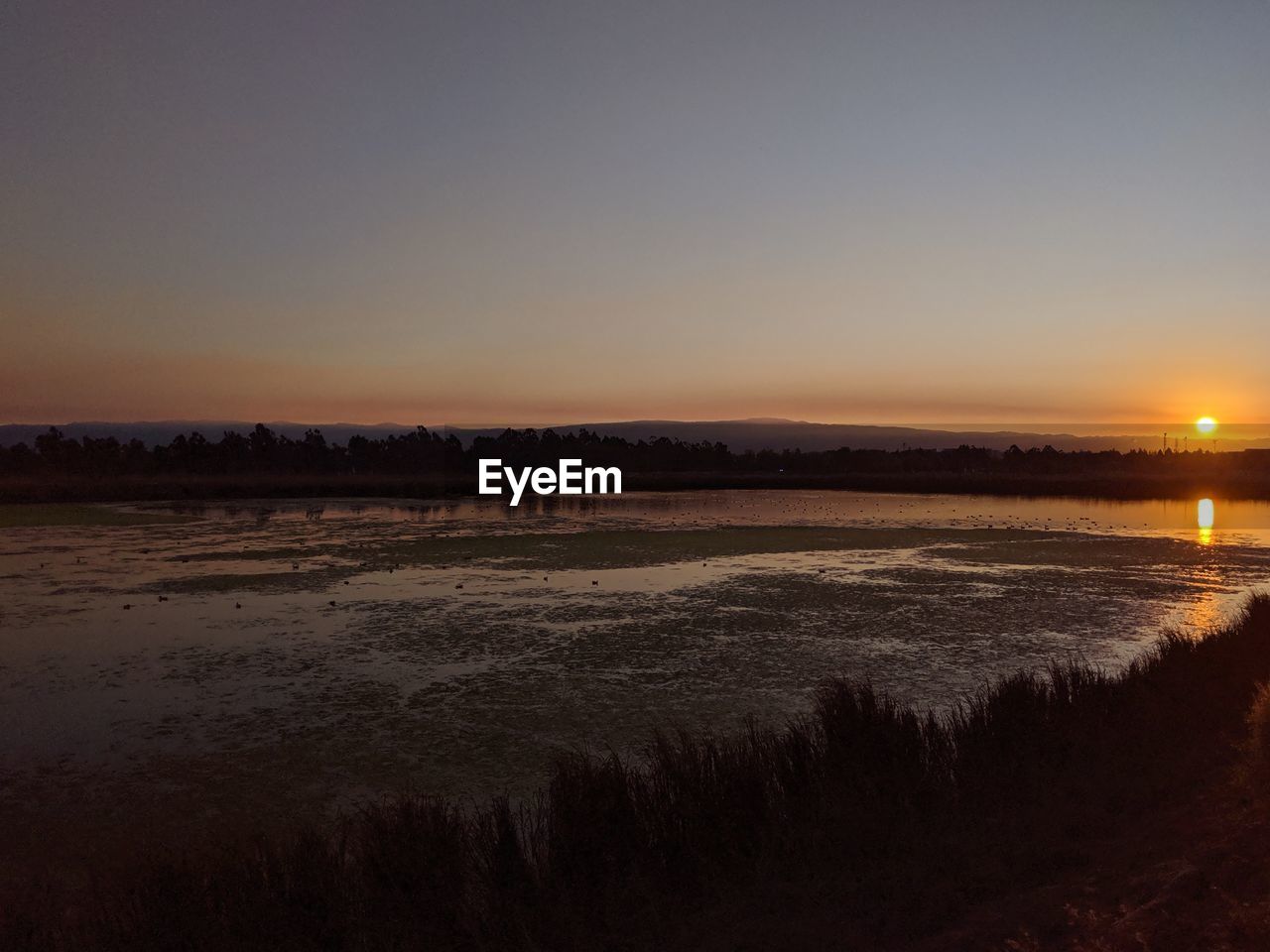 SCENIC VIEW OF SUNSET OVER LAND