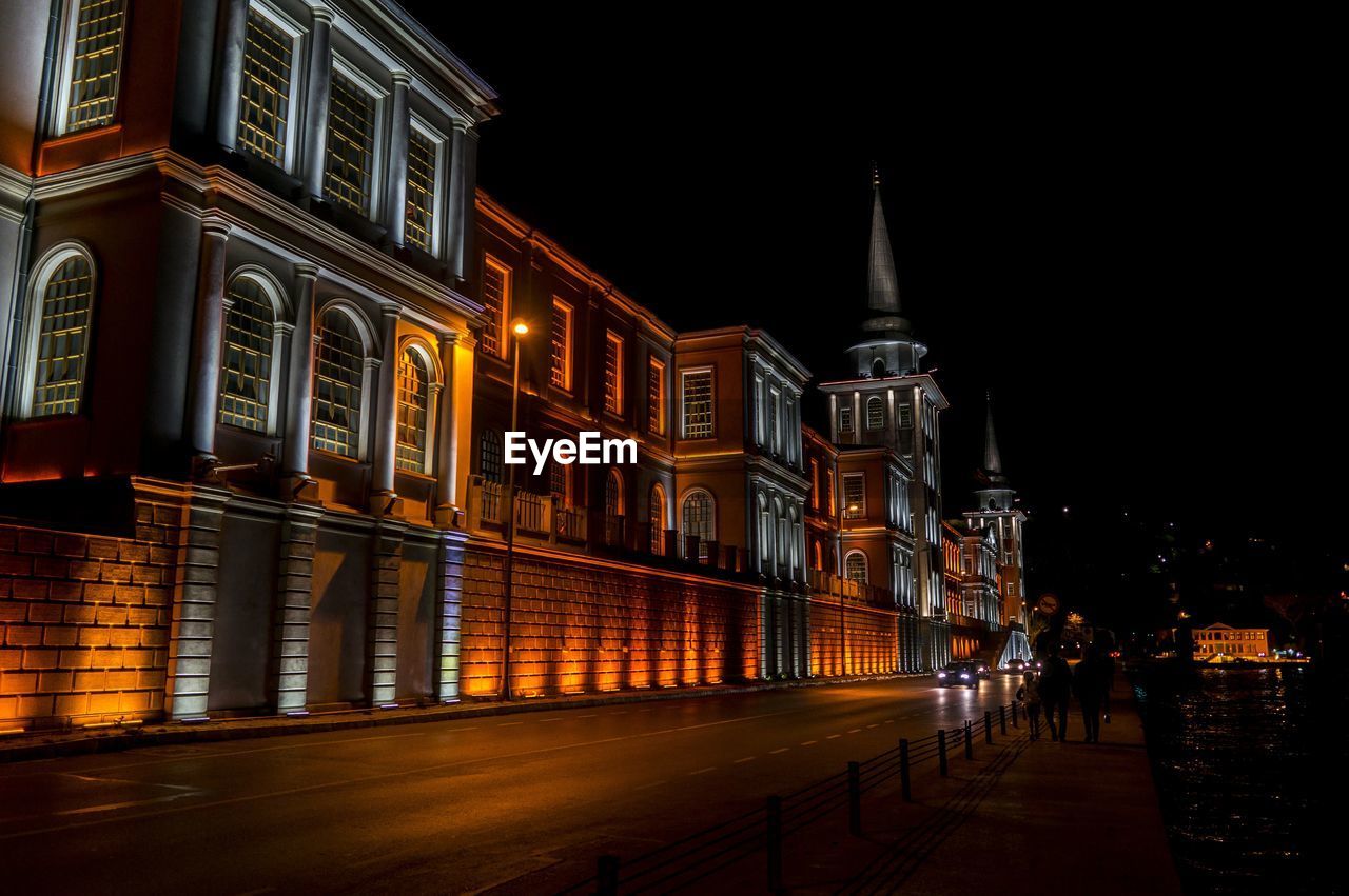 ILLUMINATED CITY BUILDINGS AT NIGHT