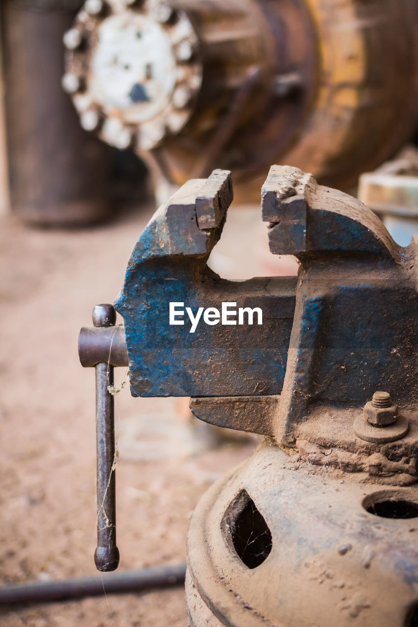 CLOSE-UP OF OLD RUSTY MACHINE PART