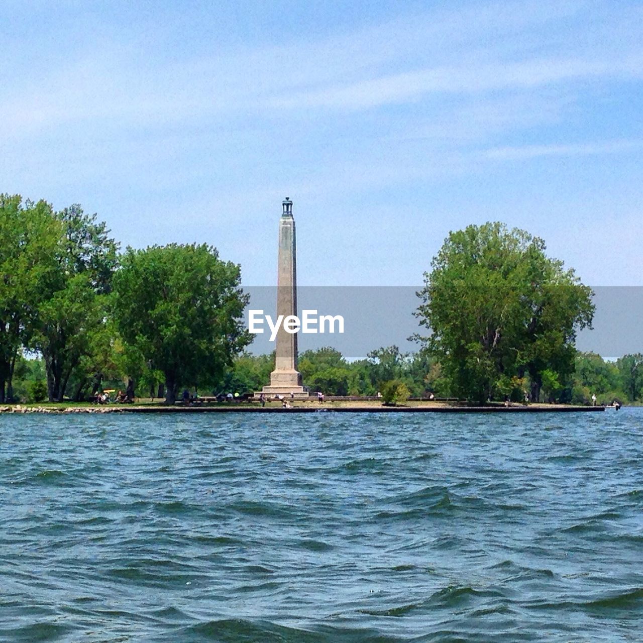 VIEW OF RIVER WITH TREES IN FOREGROUND