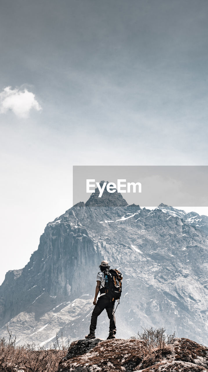 A man looking at a mountain peak