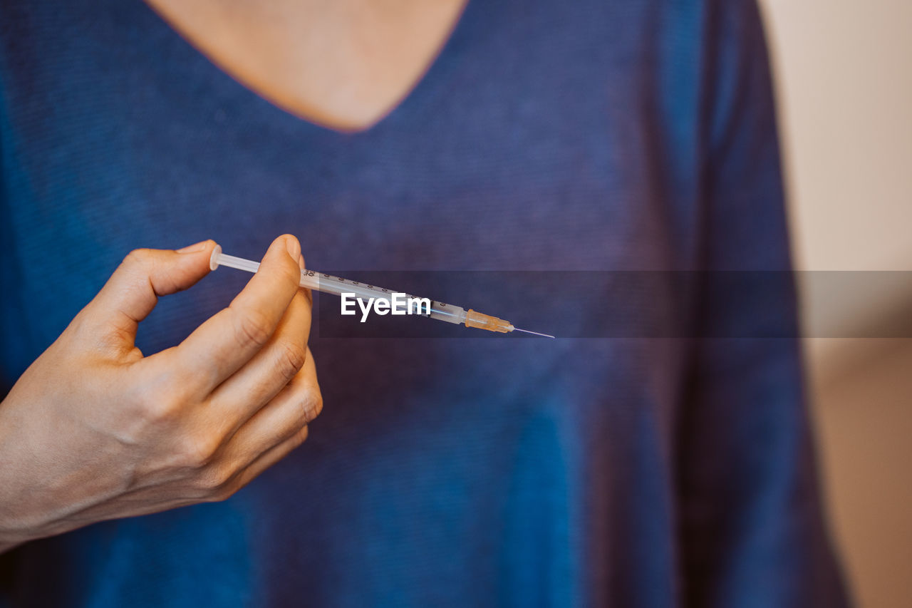 Close-up of hand holding cigarette