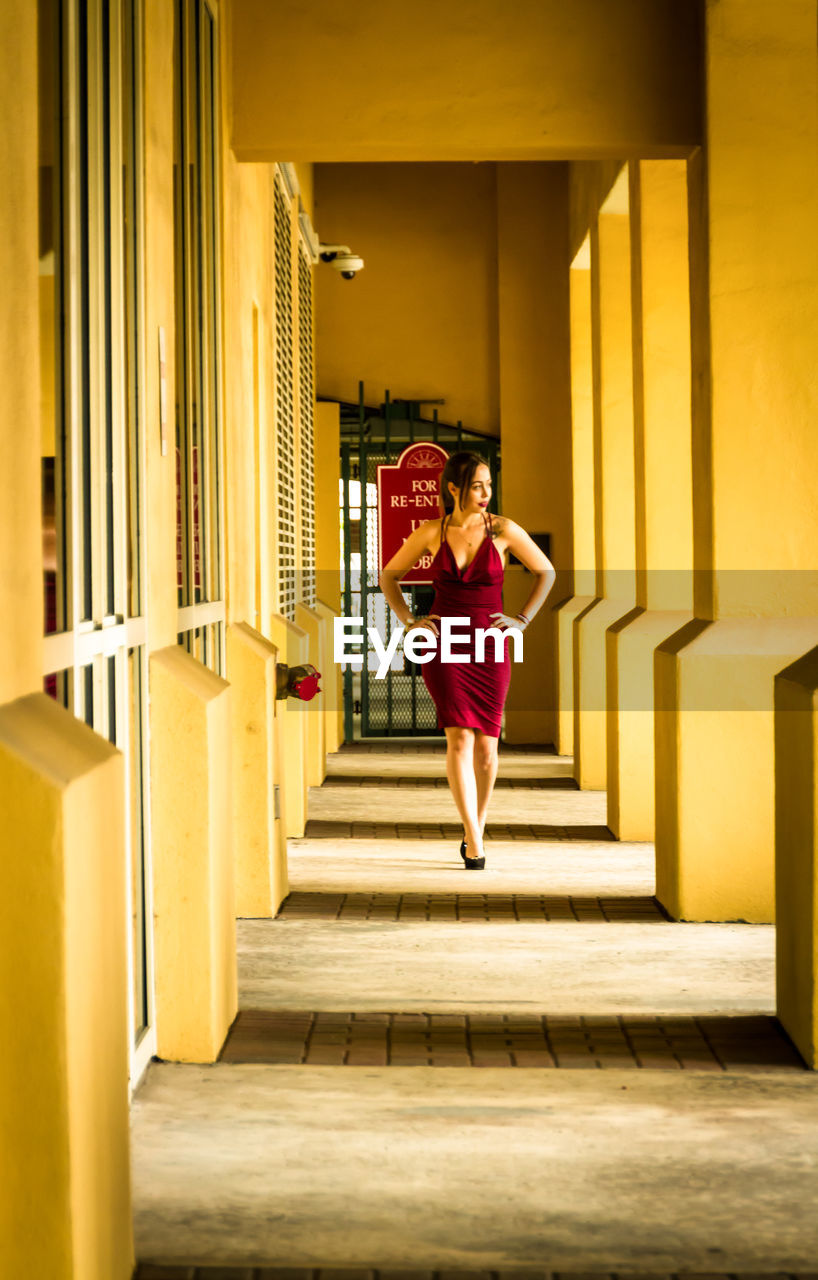 Full length of woman standing in corridor