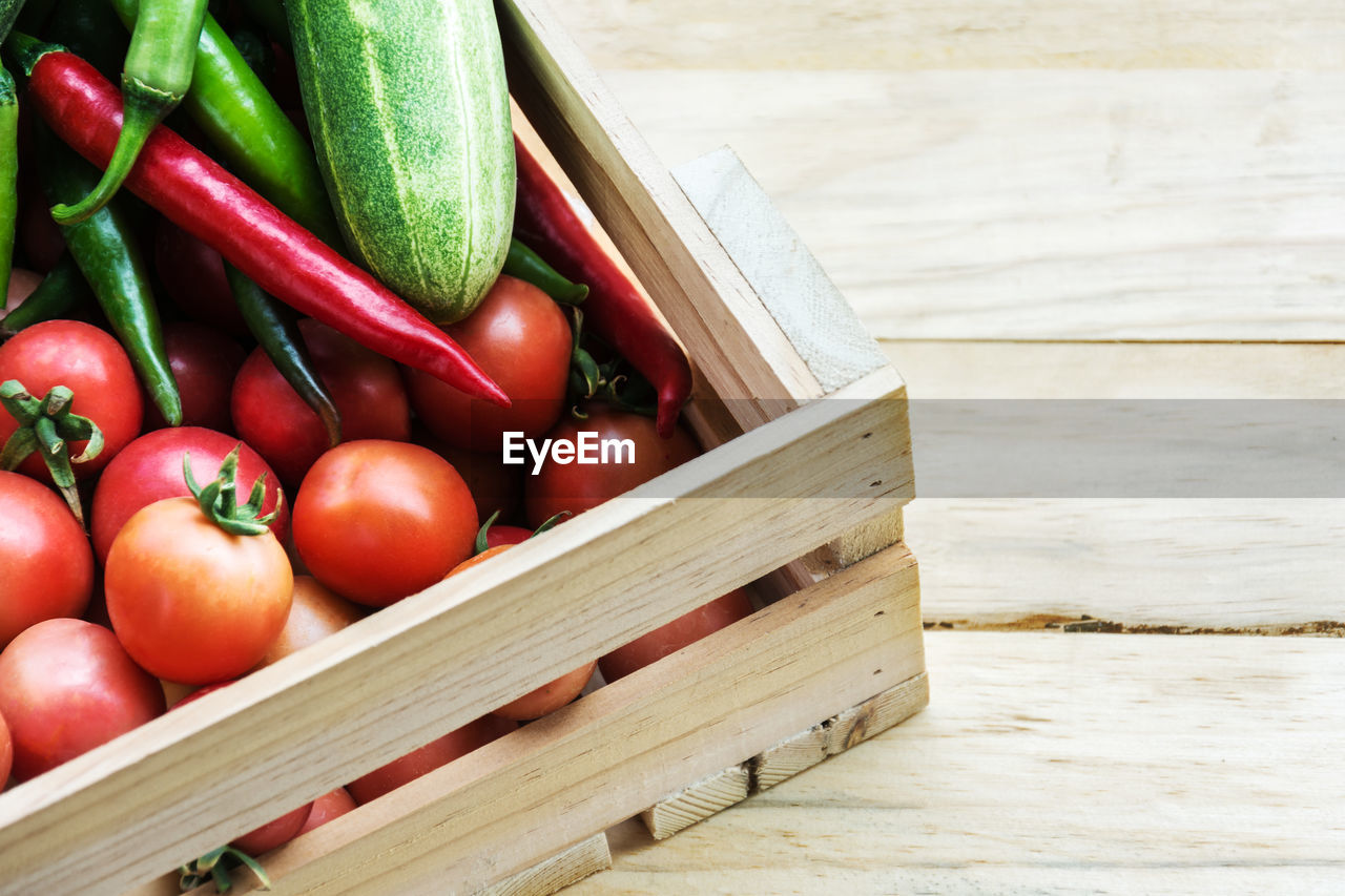 High angle view of tomatoes in wooden container on table