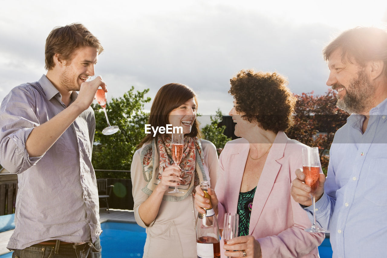 Happy people drinking champagne together