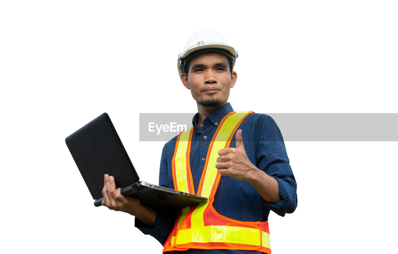 LOW ANGLE VIEW OF MAN HOLDING MOBILE PHONE