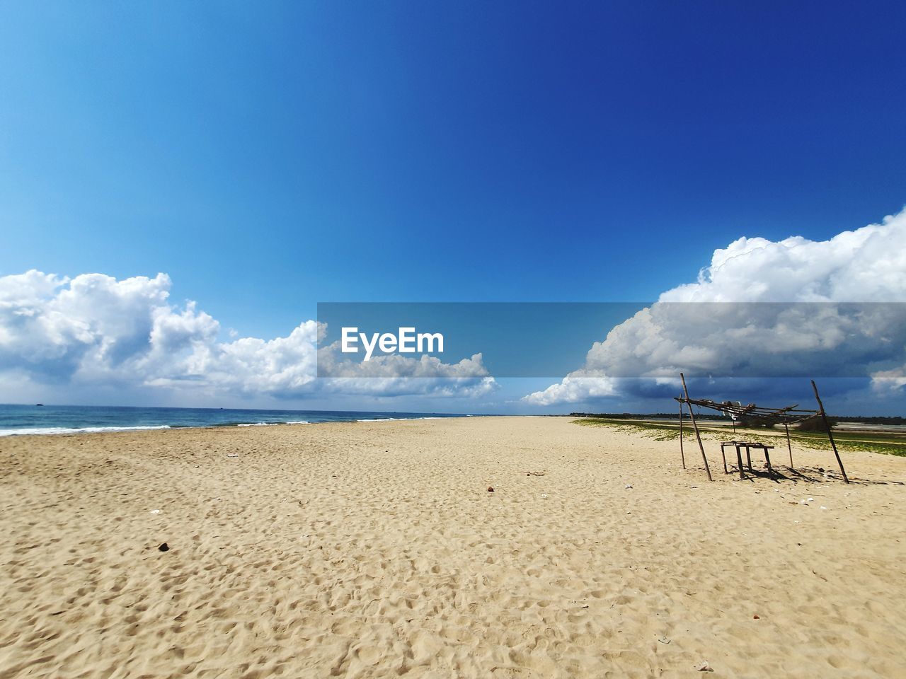 PANORAMIC VIEW OF BEACH AGAINST BLUE SKY