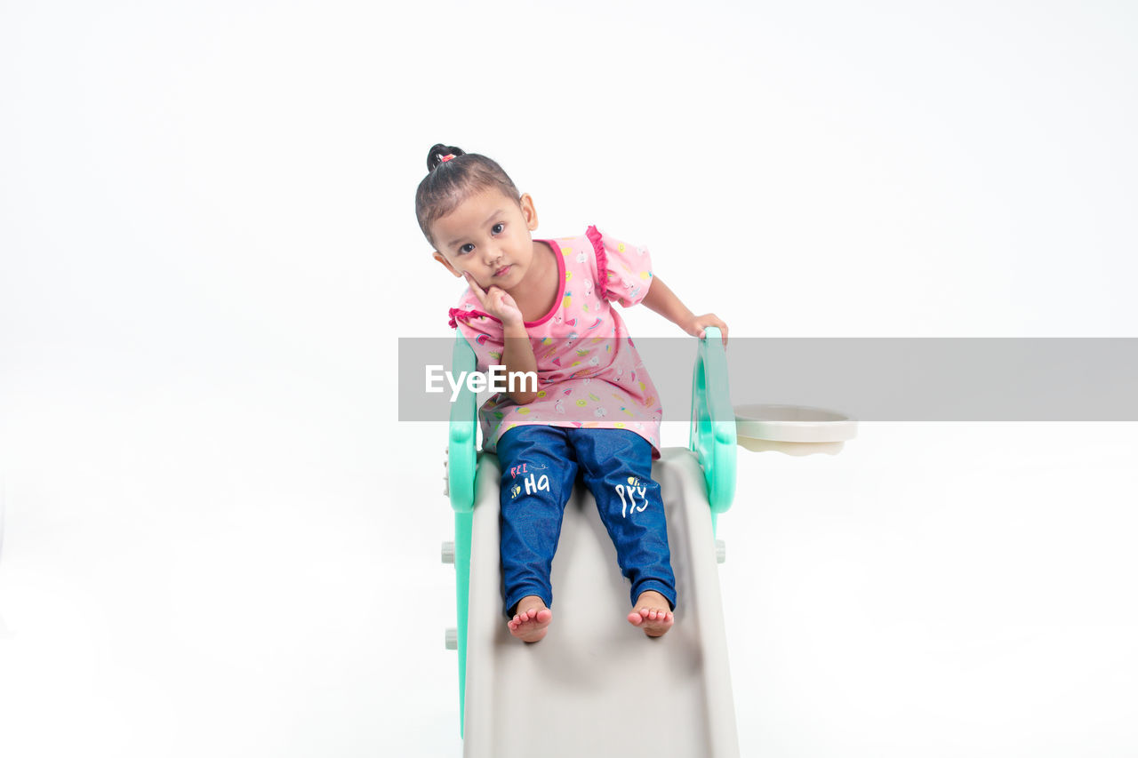 child, childhood, one person, full length, white background, toddler, cute, copy space, clothing, casual clothing, happiness, emotion, fun, indoors, front view, innocence, smiling, person, lifestyles, portrait, women, studio shot, baby, female, holding, cheerful