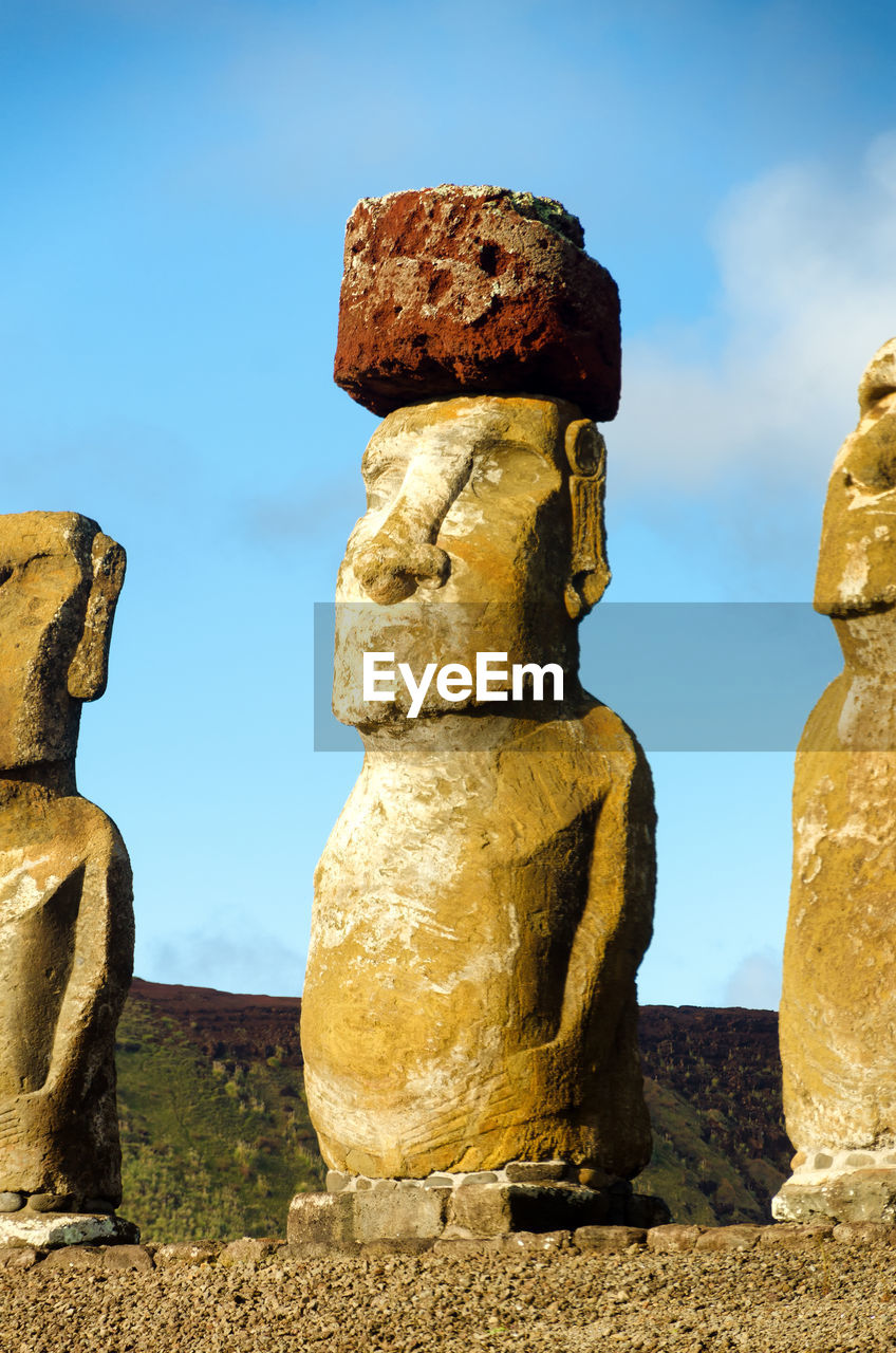 Pukao statues at rapa nui national park against sky