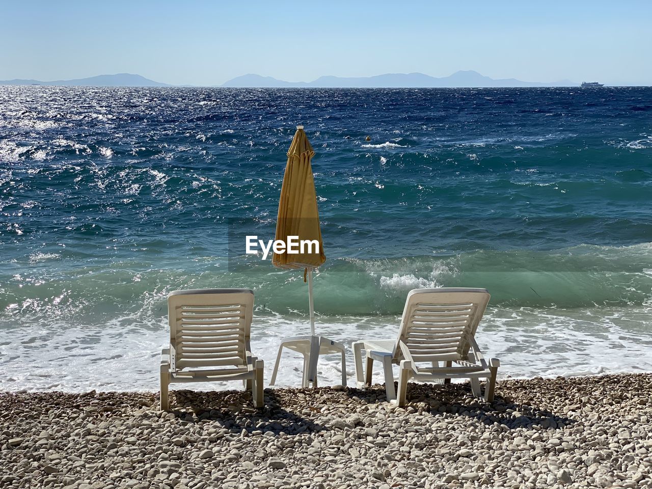 CHAIRS ON BEACH AGAINST SEA