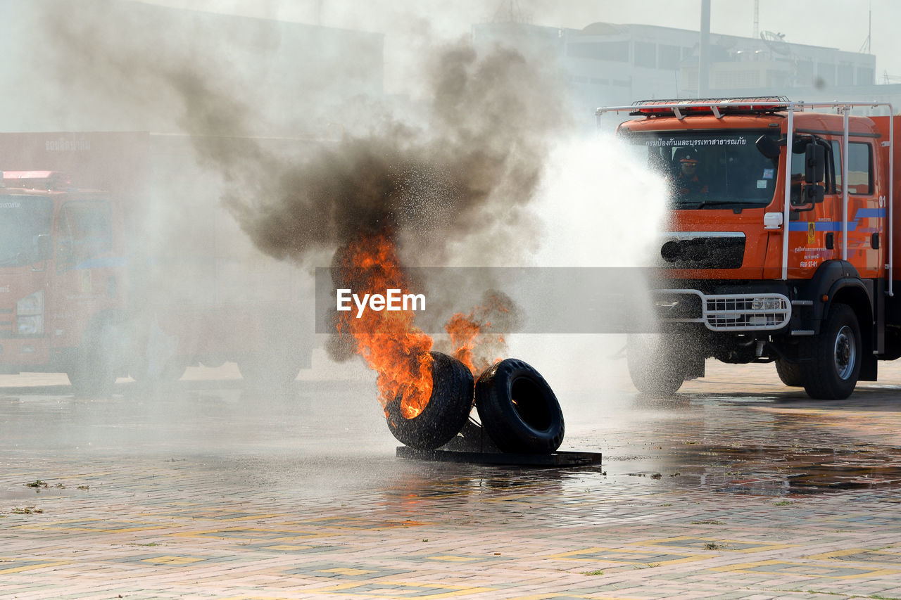 Tires burning on road in city