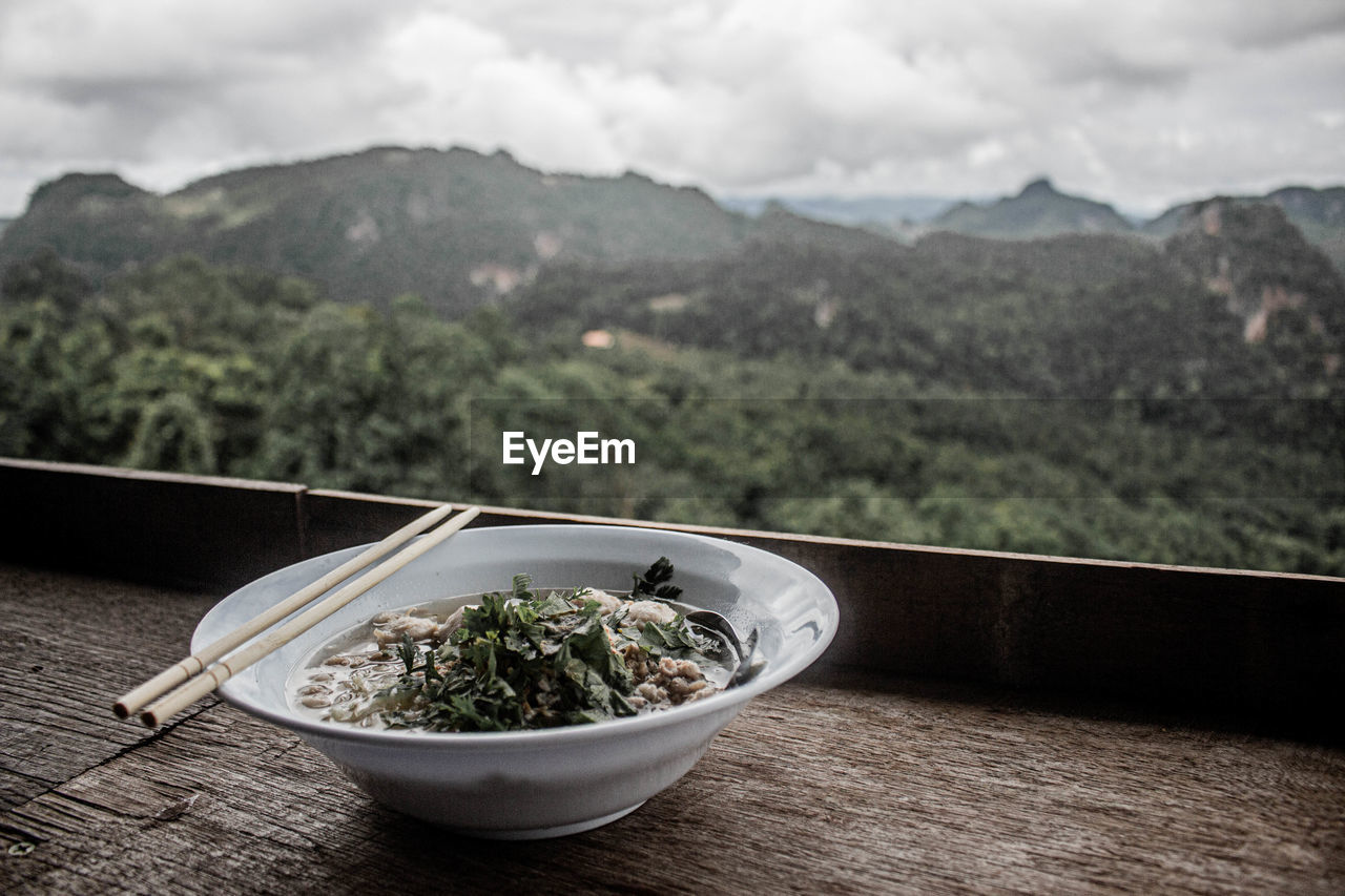 Close-up of food on table against mountains