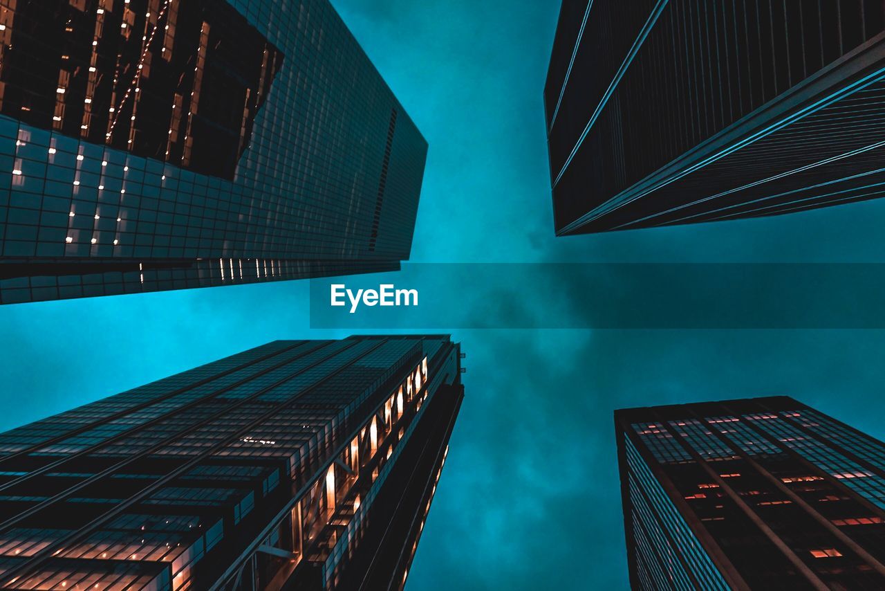 Low angle view of modern buildings against sky at night