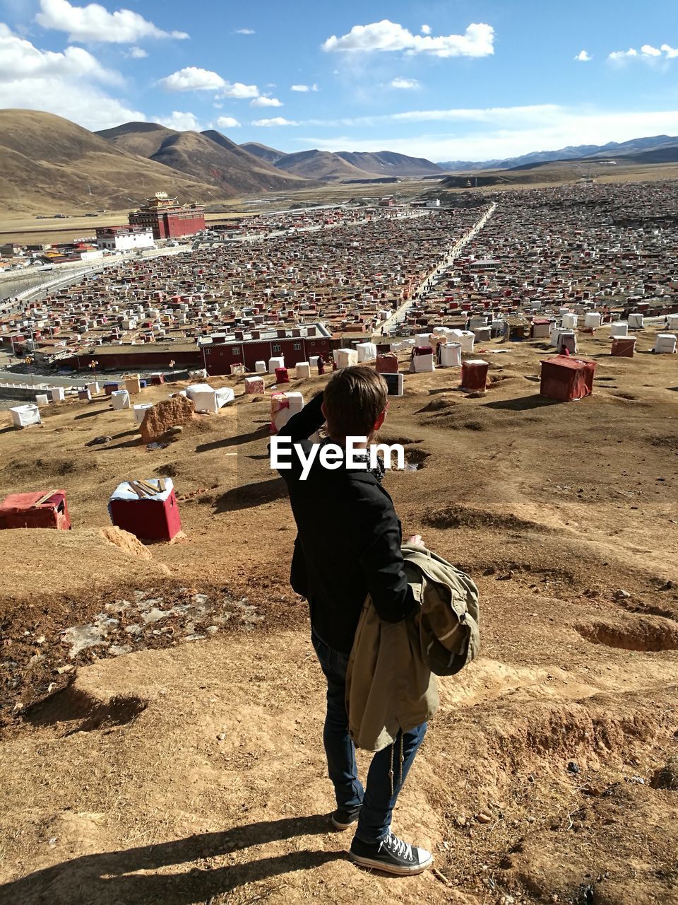 REAR VIEW OF A WOMAN ON MOUNTAIN