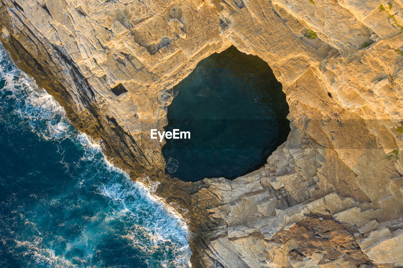 High angle view of rock formations in sea