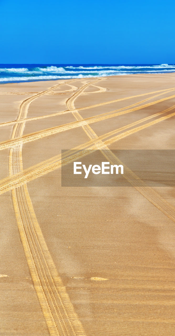 VIEW OF TIRE TRACKS ON SAND