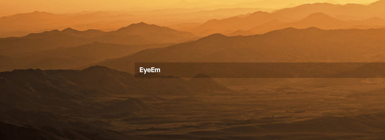 Scenic view of mountains against sky during sunset