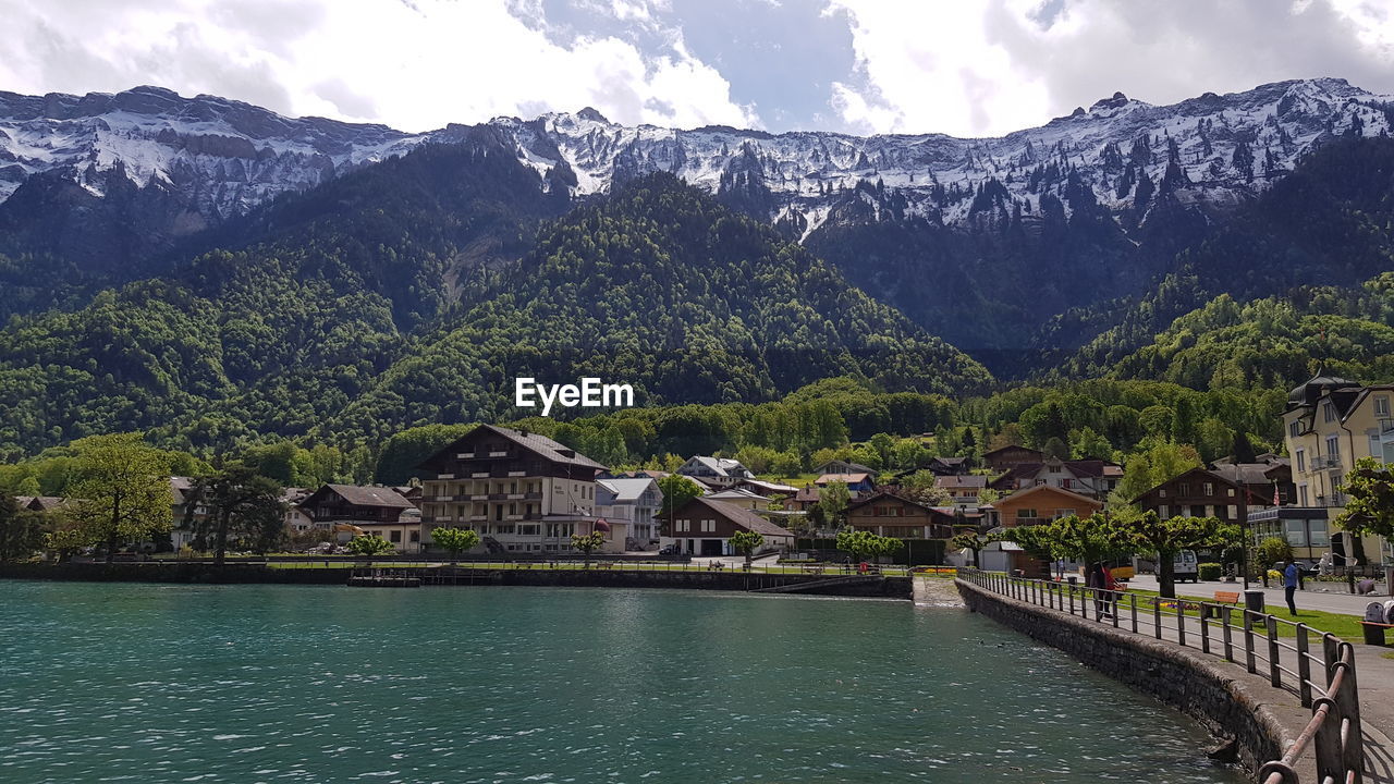 Scenic view of river and buildings against sky