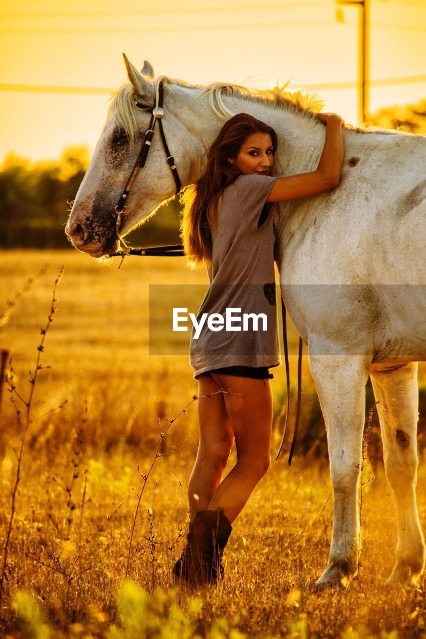 Portrait of young woman standing in ranch