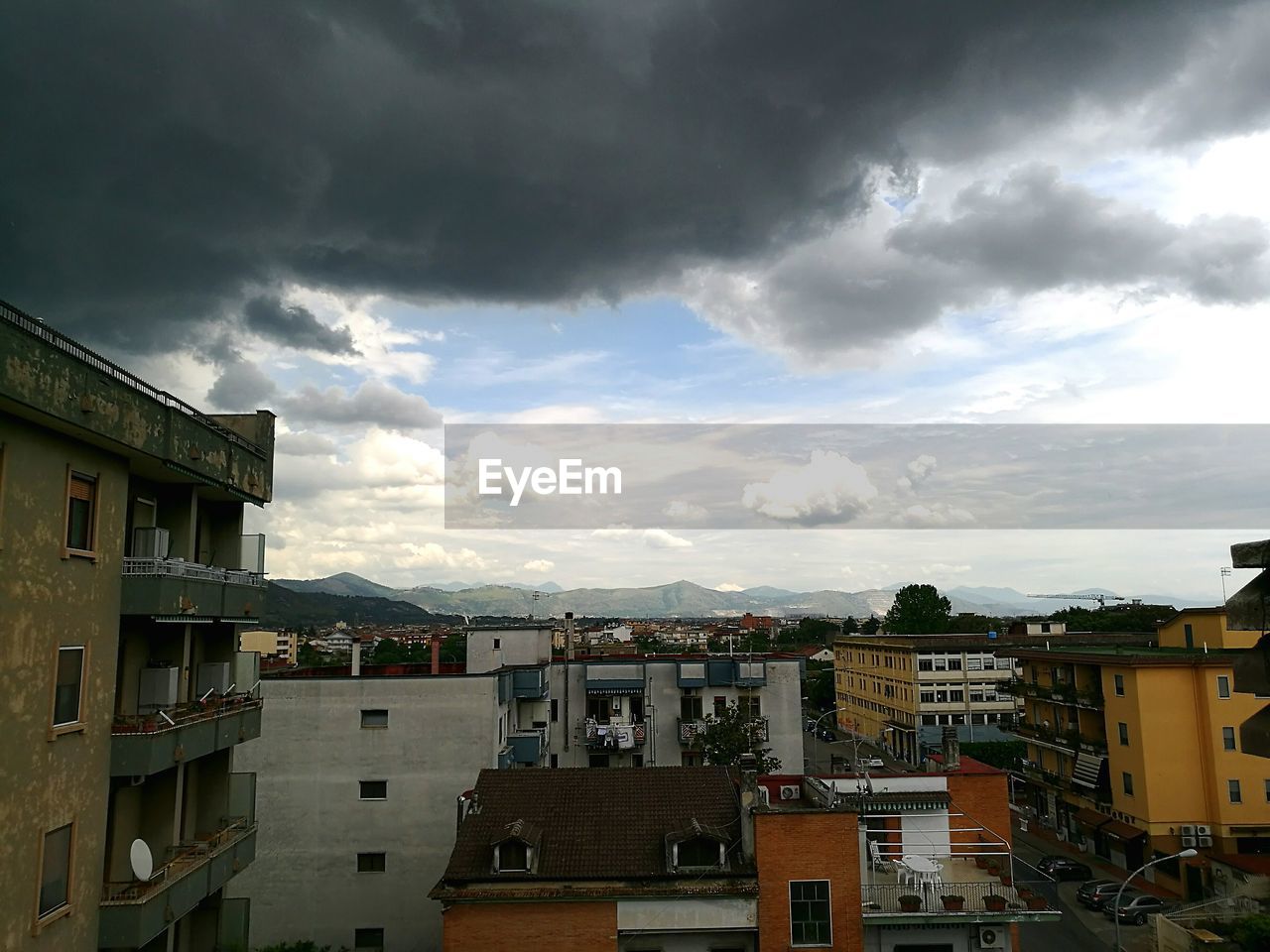 Buildings against cloudy sky