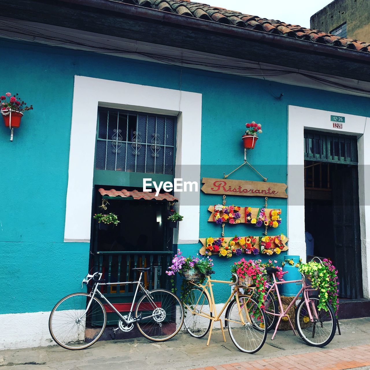 BICYCLE PARKED AGAINST BUILDING