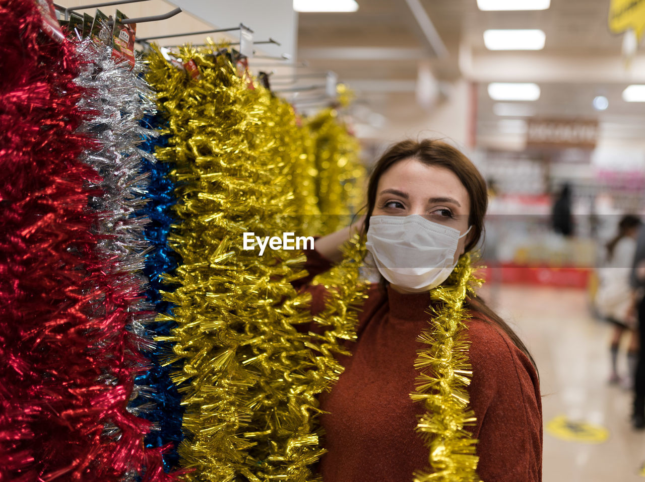 Woman wearing mask shopping at mall