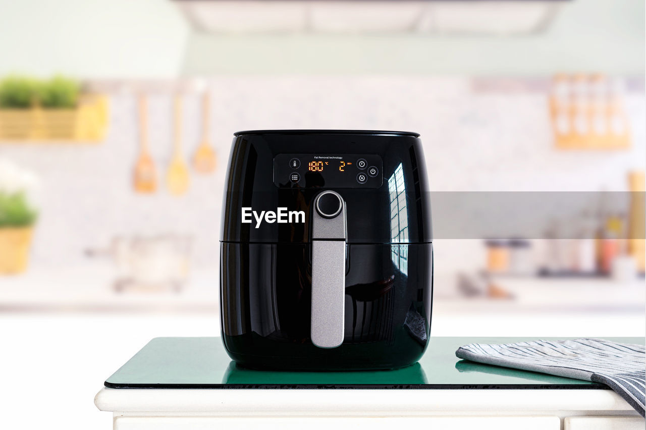 Air fryer machine cooking potato fried in kitchen. lifestyle of new normal cooking.