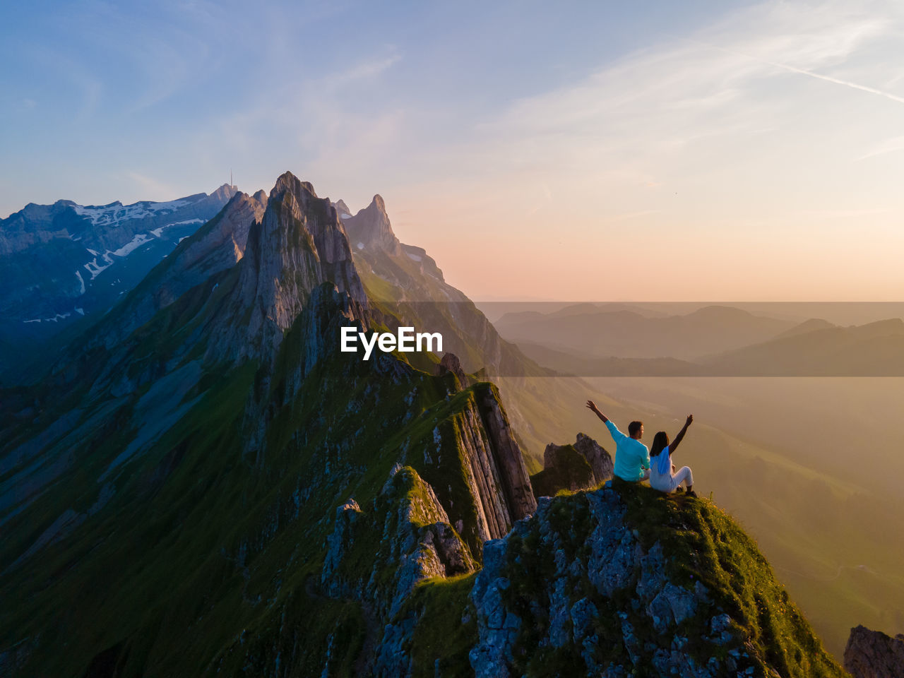 rear view of man standing on mountain against sky