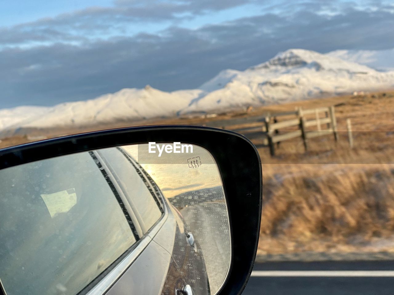 REFLECTION OF MOUNTAINS ON SIDE-VIEW MIRROR